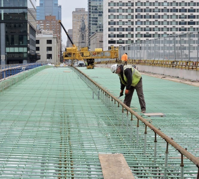 An ironworker checks the rebar as the contractor prepares to pave the westbound side of the Chestnut Street Bridge.