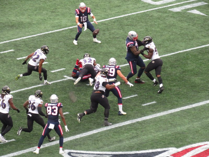 Patriots QB Mac Jones (#10) receives a pitch from RB Rhamondre Stevenson on a two-point conversion attempt in the 4th qtr. against the Baltimore Ravens. Stevenson was ruled down before he flipped the ball to Jones, so the attempt was unsuccessful, 9/25/22