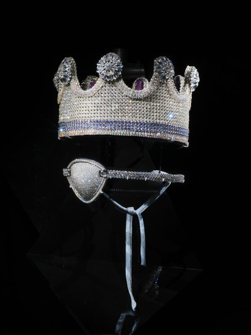 Designed by Slick Rick, who embraces grandeur and royalty in his style, this costume jewelry piece is by Tanya Jones of Lucki Crowns. Presented with the crown is a custom-made eyepatch designed for Slick Rick by Jacob & Co in 2012, with refinements by Avianne & Co in 2023, featuring platinum and diamonds.