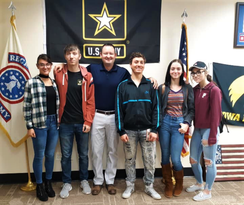 The five Wierzbicki siblings, Haley, Mason, Austin, Sequia and Sierra, take a photo with Staff Sgt. Lucas Jansson