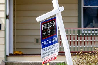 FILE This April 16, 2020 photo shows a real estate company sign marking a home for sale in Harmony, Pa. U.S. homeowners are seizing on historically low mortgage rates to refinance their mortgages. (AP Photo/Keith Srakocic)