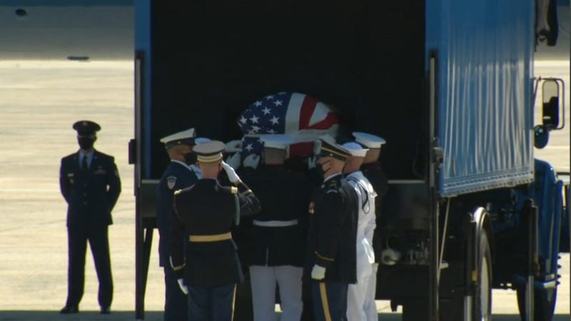 The body of the late Rep. John Lewis is placed on the plane to be flown to Atlanta