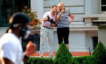 FILE - In this June 28, 2020 file photo, armed homeowners Mark and Patricia McCloskey, confront protesters marching to St. Louis Mayor Lyda Krewson's house. (Laurie Skrivan/St. Louis Post-Dispatch via AP)