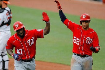 Washington Nationals' Howie Kendrick (47) is greeted with "air high fives" by Juan Soto (22) after Kendrick scored them both on a two-run home run. (AP Photo/Julio Cortez)