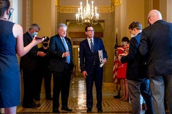 Treasury Secretary Steven Mnuchin, right, accompanied by White House chief of staff Mark Meadows, left, take a question from a reporter following a meeting with Senate Majority Leader Mitch McConnell of Ky. (AP Photo/Andrew Harnik)