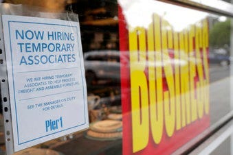A sign advertises hiring of temporary associates at a Pier 1 retail store, which is going out of business, during the coronavirus pandemic, Thursday, Aug. 6, 2020, in Coral Gables, Fla. (AP Photo/Lynne Sladky)