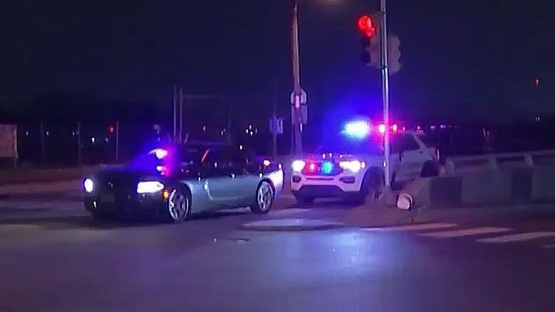 Police investigate an undercover officer's car after it was shot by an unknown assailant last week. The officer was injured by glass and treated at a hospital.