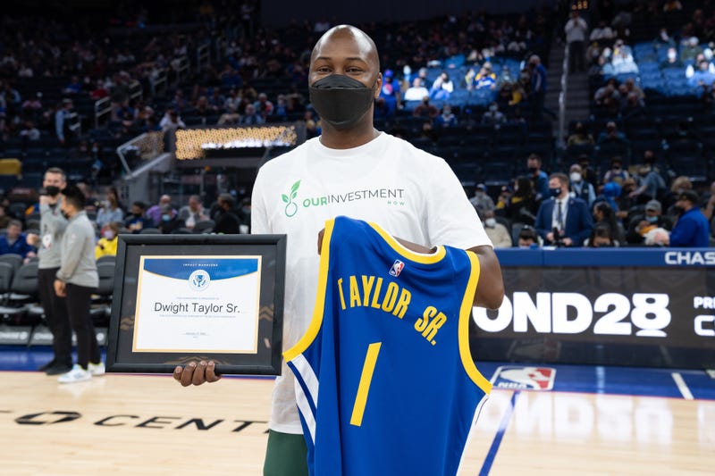 Dwight Taylor Sr. being honored at a Warriors game.