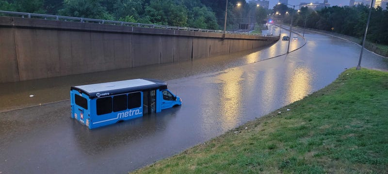 Metro transit bus half submerged on the road