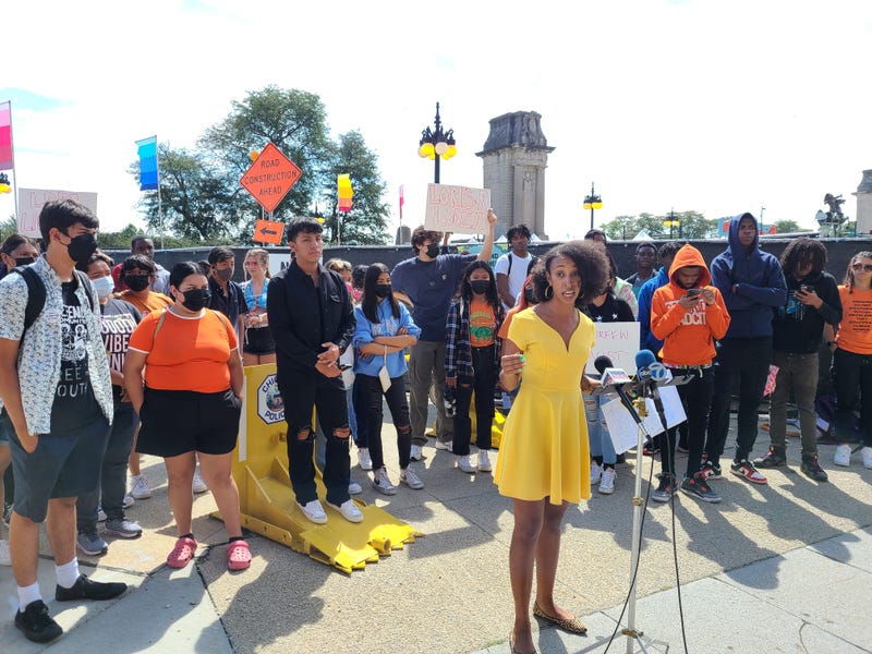 Kara Crutcher speaks in front of dozens of activists