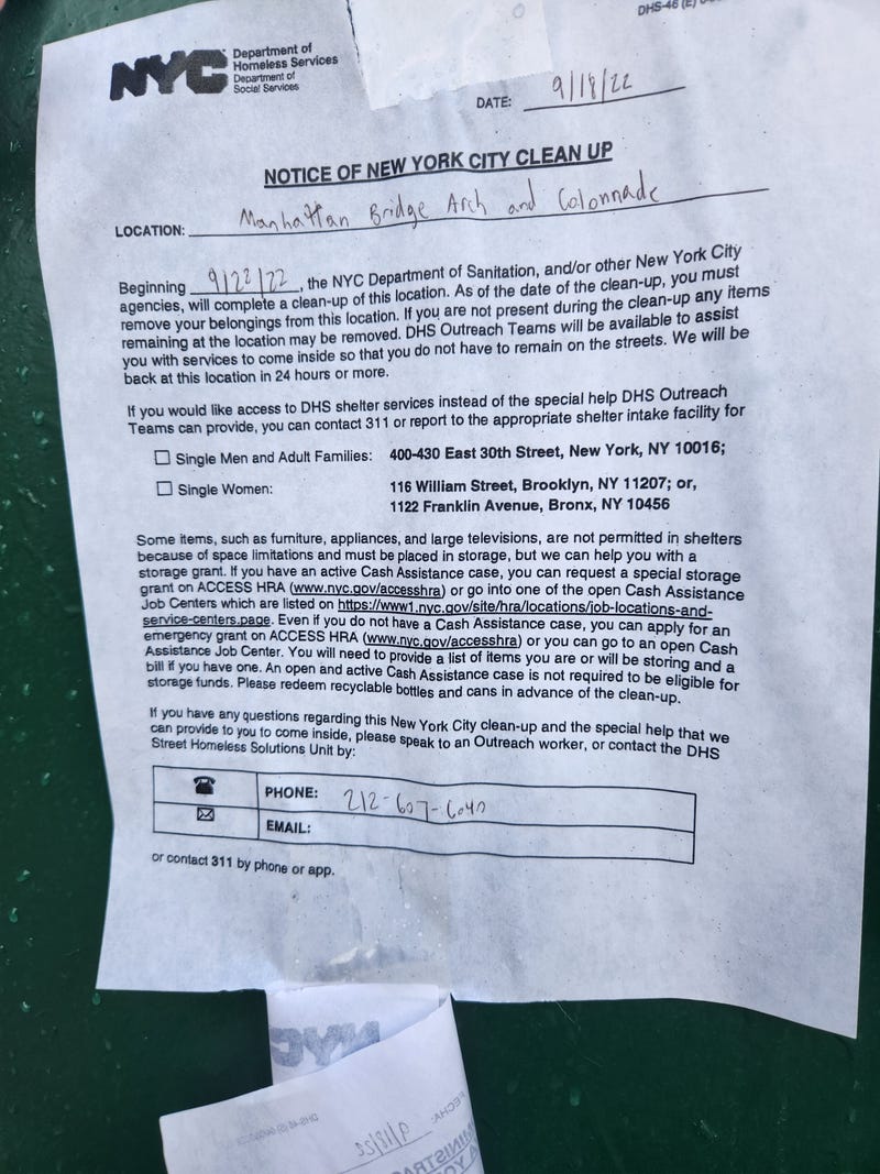 A sweep notice posted on an electric box about 100 feet from the targeted encampment.