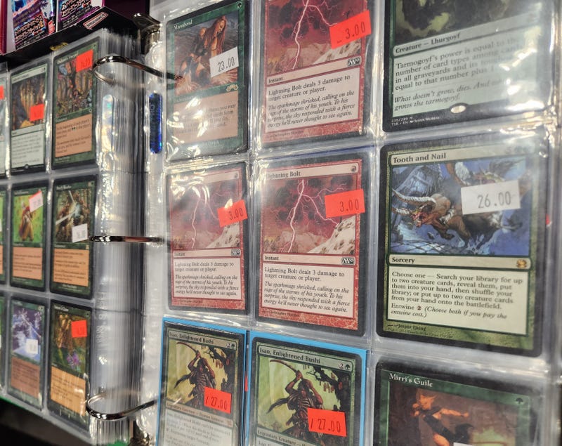 A binder full of Magic: The Gathering cards on display at The Nerd Out stand at New York Comic Con 2022.