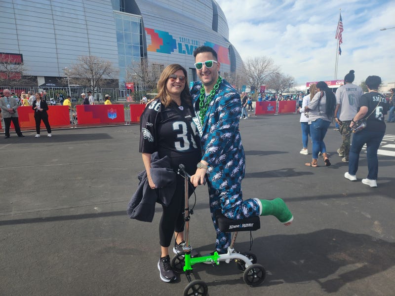 Eagles fan Michael Gordon (right) with his wife Lauren and his mobility scooter, outside State Farm Stadium in Glendale, Arizona for Super Bowl LVII.