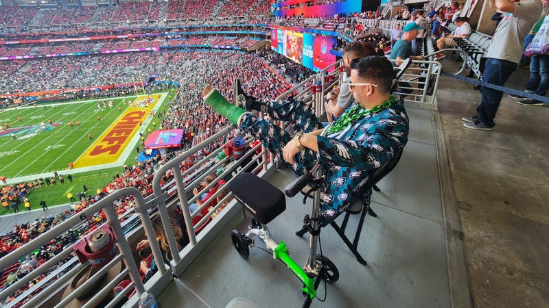 Michael Gordon sitting with his legs elevated at State Farm Stadium in Glendale, Arizona during Super Bowl LVII.