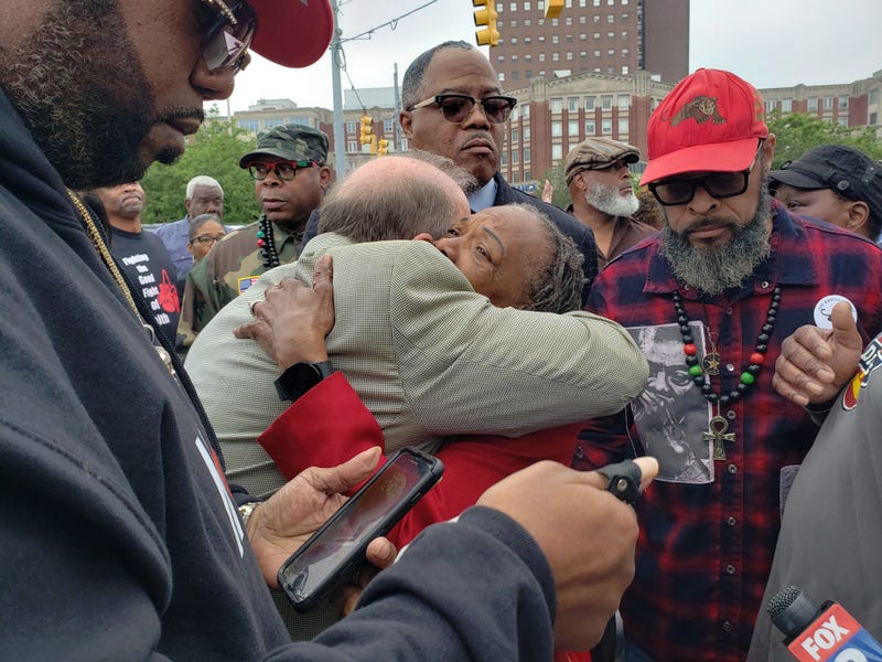 Mayor Mike Duggan hugs Wanda Akilah Redmond, the wife of longtime Detroit community advocate Malik Shabazz.