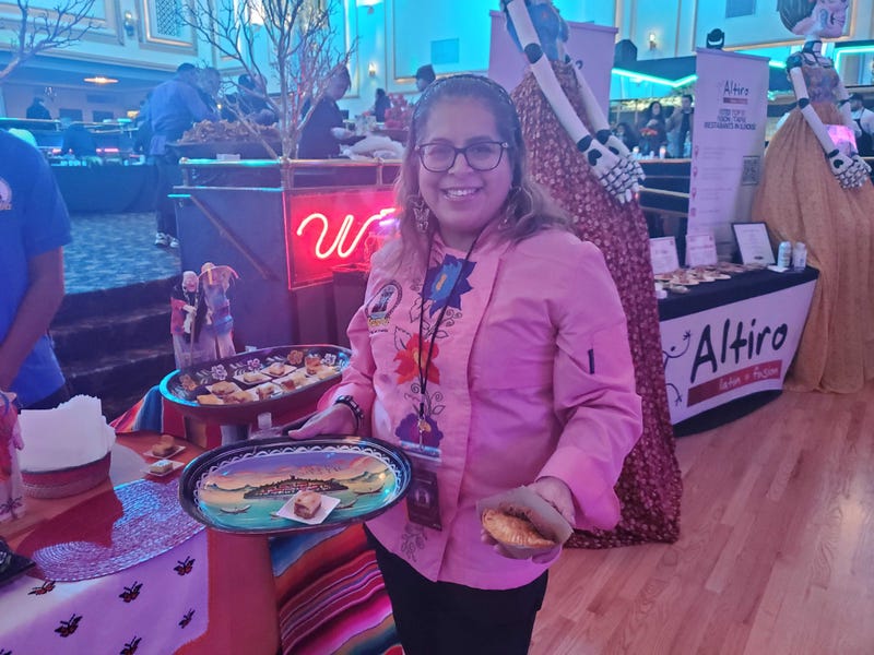 Atzimba Perez, owner and founder of Atzimba Catering, holds her food featured at Pilsen Gourmet.