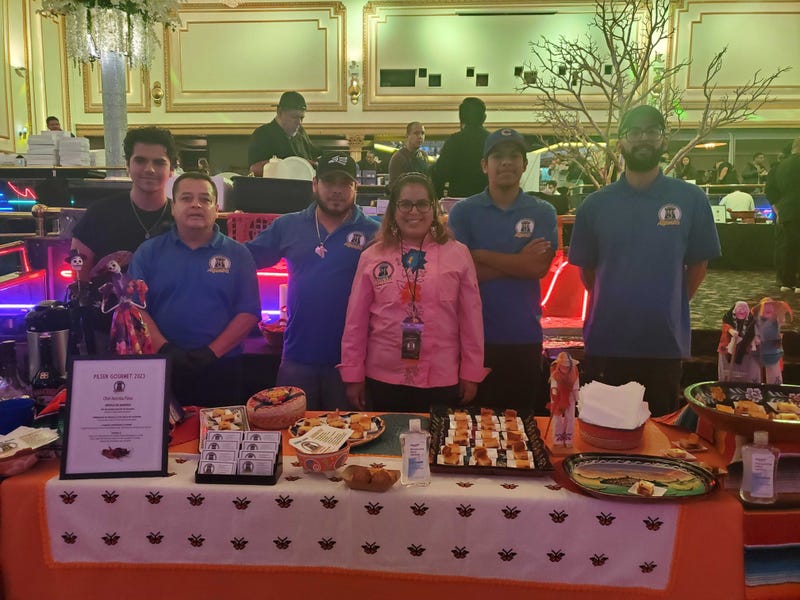 Atzimba Perez, owner and founder of Atzimba Catering, stands with her team at the Pilsen Gourmet Festival.