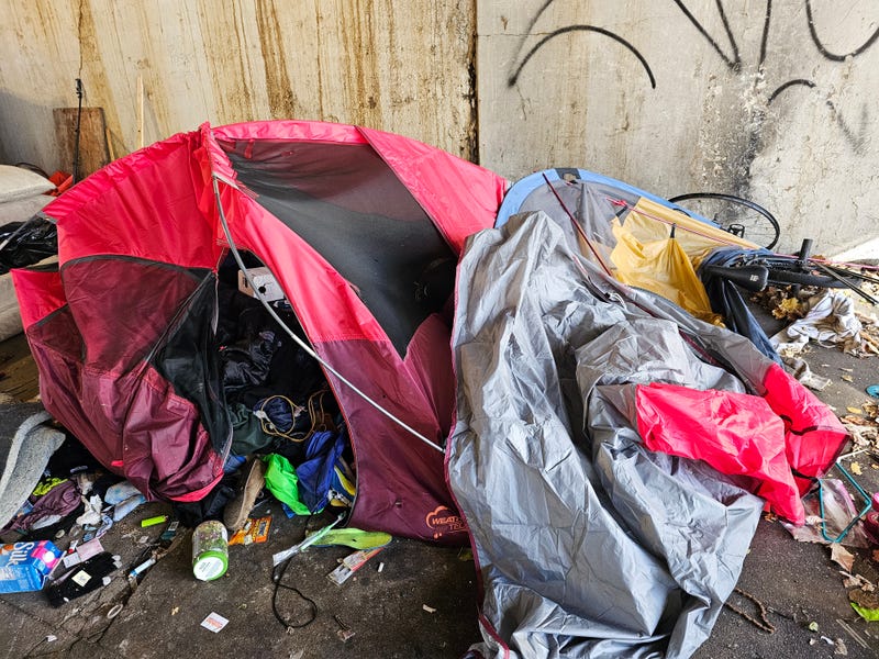 Tents and possessions scattered across the sidewalk at the Clinton and Lake Streets viaduct.