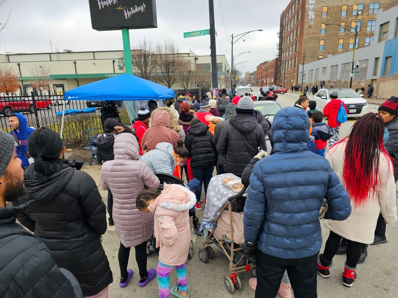 Migrants line up for a hot meal on Chicago's Lower West Side.