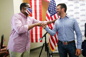 Donald Trump Jr., right, meets with congressional candidate Burgess Owens and volunteers at Colonial Flag in Sandy, Utah, Thursday, July 23, 2020. (Jeffrey D. Allred/The Deseret News via AP)
