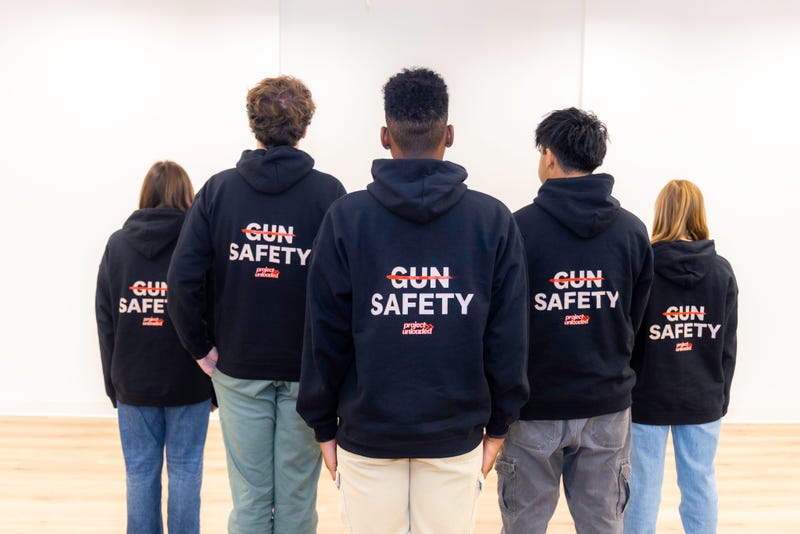 backs of Project Unloaded kids wearing gun safety hoodies