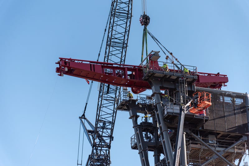 Crews lift Siren's Curse tilt track into place