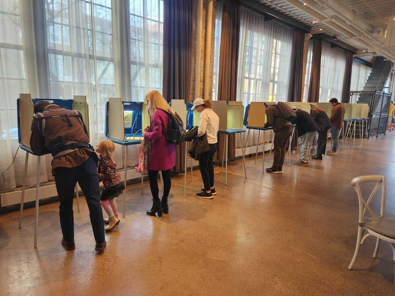 Current Minneapolis Mayor Jacob Frey casts his vote early Tuesday morning with his family at the Machine Shop in St. Anthony Main in NE Minneapolis.