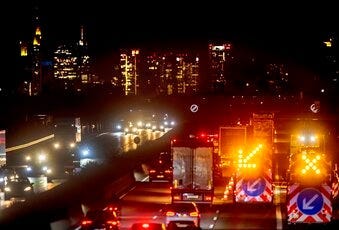 Cars and trucks drive on the main highway with the buildings of the banking district in background in Frankfurt, Germany, Monday, Sept. 14, 2020. (AP Photo/Michael Probst)