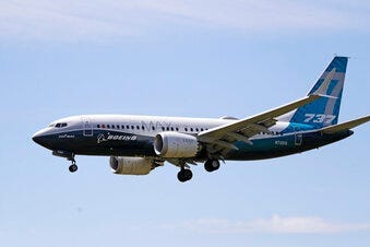 FILE - In this Monday, June 29, 2020, file photo, a Boeing 737 Max jet heads to a landing at Boeing Field following a test flight in Seattle. (AP Photo/Elaine Thompson, File)