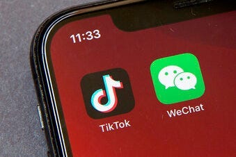 FILE - Icons for the smartphone apps TikTok and WeChat are seen on a smartphone screen in Beijing, in a Friday, Aug. 7, 2020 file photo. (AP Photo/Mark Schiefelbein, File)