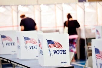 In this Sept. 8, 2020 photo, voting booths are kept socially distant at the Chesterfield, N.H. polling site. (Kristopher Radder/The Brattleboro Reformer via AP)