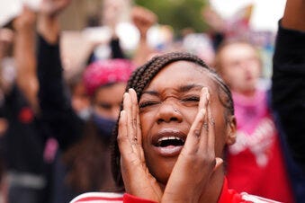 A woman speaks during a protest, Wednesday, Sept. 23, 2020, in Louisville, Ky. A grand jury has indicted one officer on criminal charges six months after Breonna Taylor was fatally shot by police in Kentucky.  (AP Photo/John Minchillo)