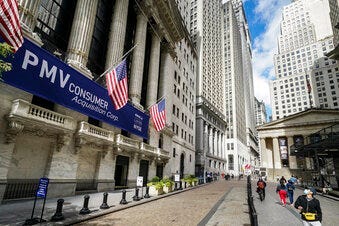 FILE - Pedestrians pass the New York Stock Exchange, Friday, Oct. 2, 2020, in New York. Stocks are opening broadly higher on Wall Street, following global markets higher on Election Day in the U.S. (AP Photo/John Minchillo)