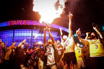 Los Angeles Lakers fans celebrate outside of Staples Center, Sunday, Oct. 11, 2020, in Los Angeles, after the Lakers defeated the Miami Heat in Game 6 of basketball's NBA Finals to win the championship. (AP Photo/Christian Monterrosa)