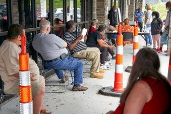 FILE - In this July 15, 2020, file photo, job seekers exercise social distancing as they wait to be called into the Heartland Workforce Solutions office in Omaha, Neb. (AP Photo/Nati Harnik, File)