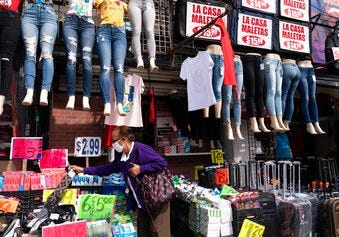 FILE - In this Sept. 25, 2020 file photo, a woman shops at a clothing store in New York. (AP Photo/Mark Lennihan, File)