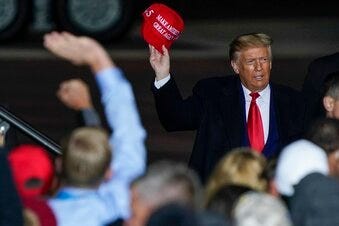 FILE - In this Sept. 17, 2020 file photo President Donald Trump throws a hat to the crowd after speaking at a campaign rally at the Central Wisconsin Airport in Mosinee, Wis. (AP Photo/Morry Gash, File)