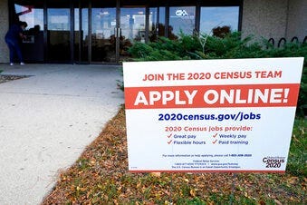 A sign is seen outside of IDES (Illinois Department of Employment Security) WorkNet center in Arlington Heights, Ill., Thursday, Nov. 5, 2020. Illinois reports biggest spike in unemployment claims of all states. (AP Photo/Nam Y. Huh)