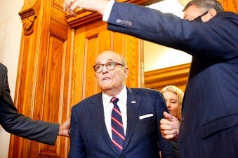 Rudy Giuliani walks to a senate hearing at the Georgia State Capitol in Atlanta on Thursday, December 3, 2020. (Rebecca Wright/Atlanta Journal-Constitution via AP)