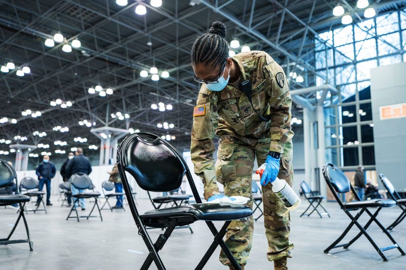 Army Spc. Mary Jones, a motor transport operator, assigned to the 719th Composite Truck Company, 369th Sustainment Brigade, 53rd Troop Command, sanitizes chairs during a mass COVID-19 vaccination event administered by the New York state health department at the Javits Convention Center in New York City, Jan. 31, 2021. The National Guard deployed more than 350 Guardsmen to help staff the vaccination site.