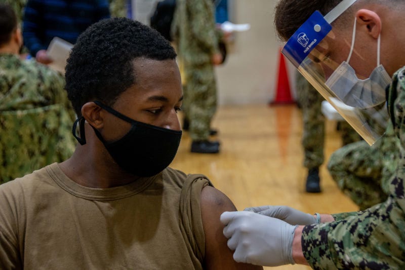 Navy Seaman Mark Reynolds, assigned to the aircraft carrier USS Ronald Reagan, receives the second shot of the COVID-19 vaccine, Yokosuka, Japan, Feb. 2, 2021. Medical personnel and strategic forces were the first to receive the COVID-19 vaccine.