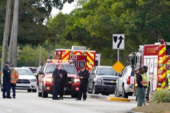 Law enforcement officers block an area where a shooting wounded several FBI while serving an arrest warrant, Tuesday, Feb. 2, 2021, in Sunrise, Fla. (AP Photo/Marta Lavandier)