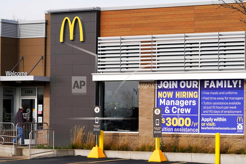 In this Nov. 19, 2020, file photo, a hiring sign is displayed outside of McDonald's in Buffalo Grove, Ill. On Wednesday, April 14, 2021, McDonald’s said the company will mandate worker training to combat harassment, discrimination and violence in its restaurants worldwide starting in 2022.