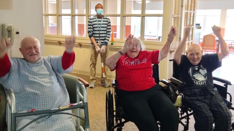 Rhoda Cohen demonstrates the wave with her friends at the Horsham Center for Jewish Life.