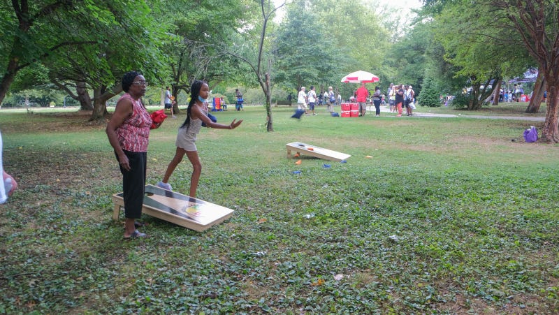 Joan Wooten and Keilah Dancy play a game of cornhole during Senior Fun Day in Fairmount Park.