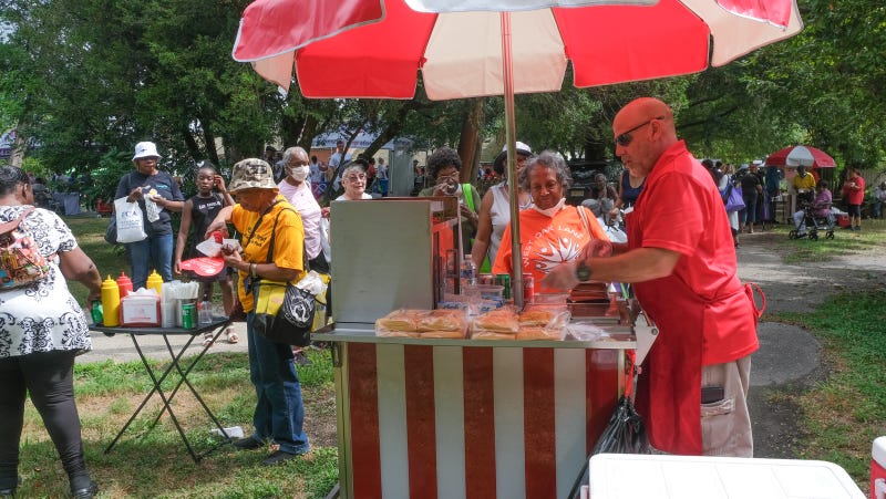 People wait in line for hot dogs during Senior Fun Day in Fairmount Park. There was also ice cream available.