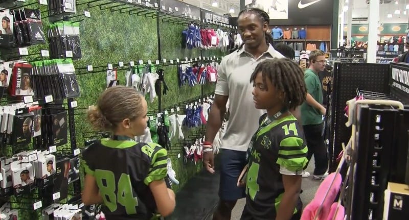 Former Eagle Anthony Harris takes a dozen youth football players football players back-to-school shopping