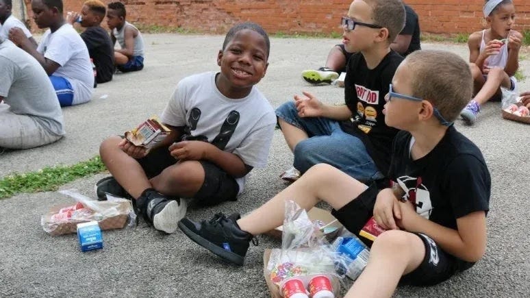 Philadelphia students enjoying food from a school meal program.