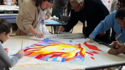 People of all ages painted sections of a mural dedicated to suicide prevention.