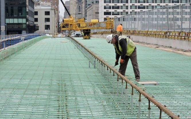 An ironworker checks the rebar as the contractor prepares to pave the westbound side of the Chestnut Street Bridge.